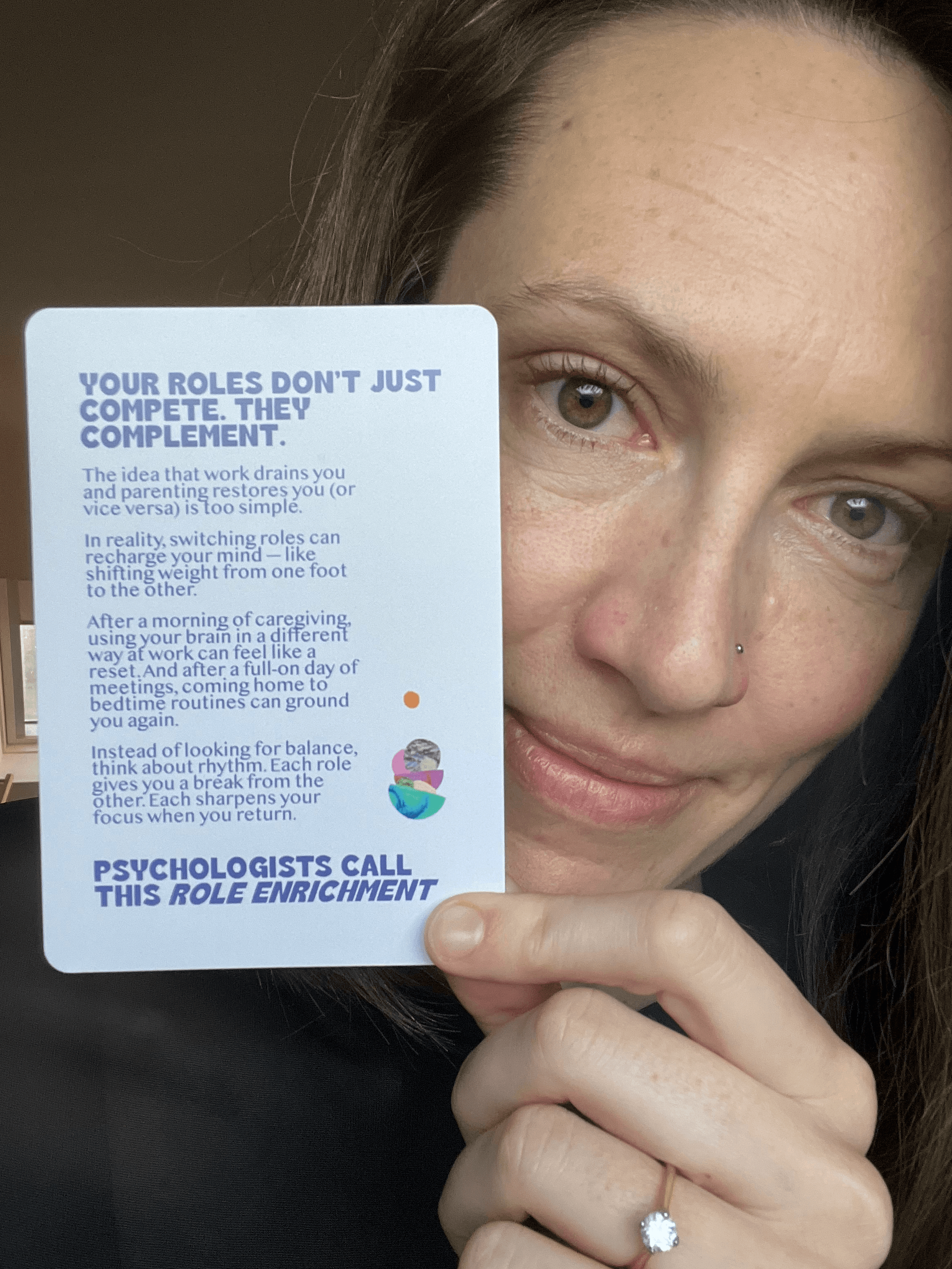 Bea, founder of The Cover Club, holding one of the cards