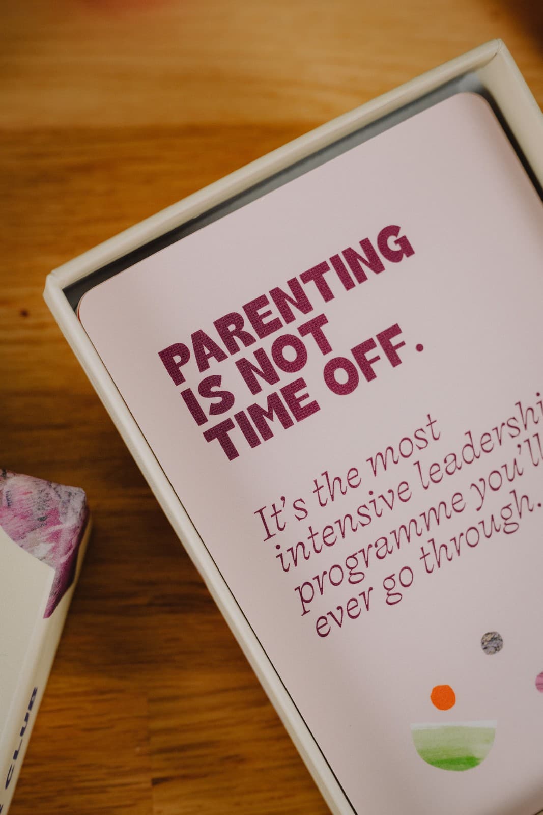 An open Cover Club box showing a card that reads parenting is not time off, it's the most intensive leadership programme you'll ever go through