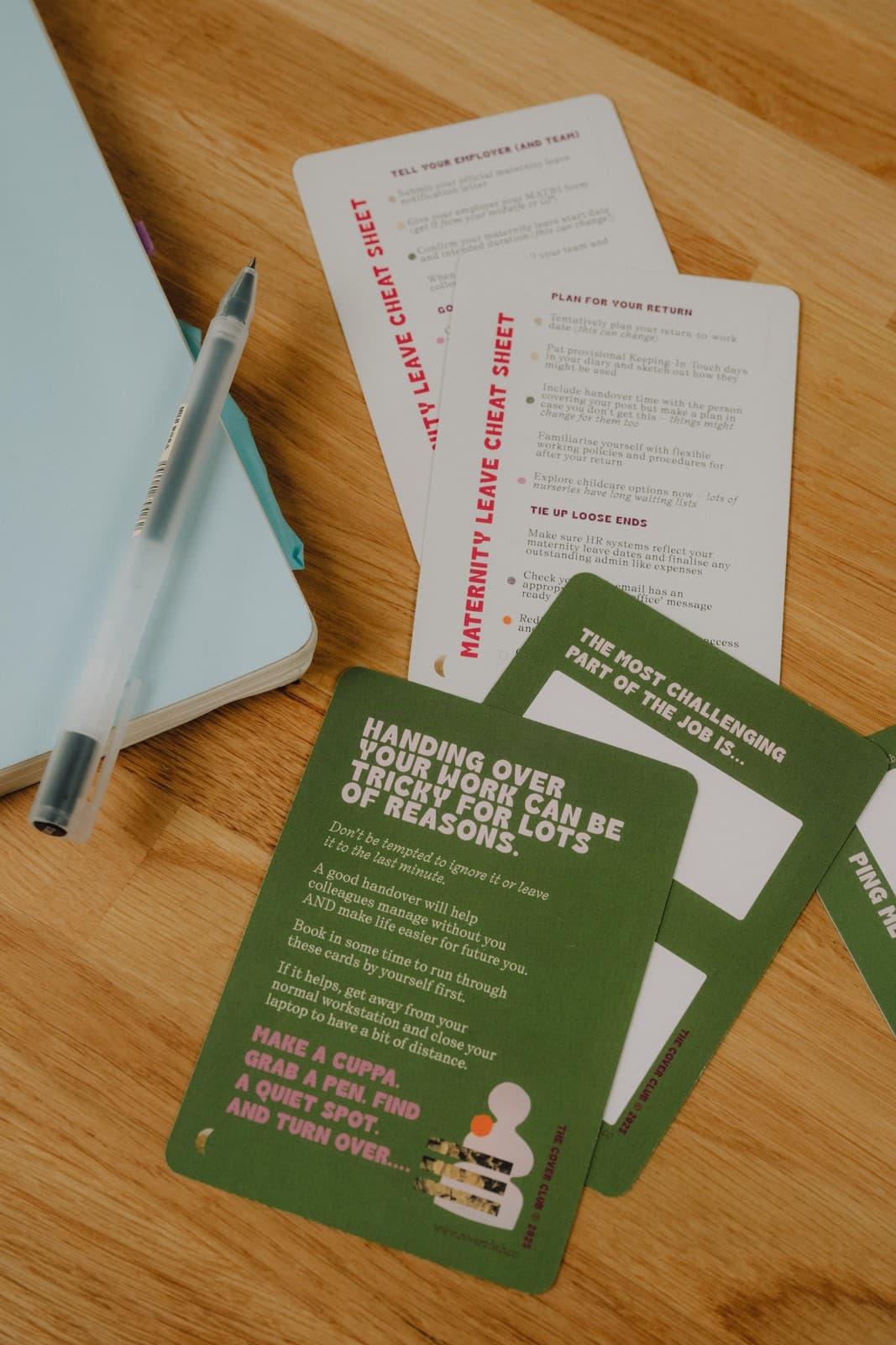 The Cover Club cards and a notebook laid out on a desk