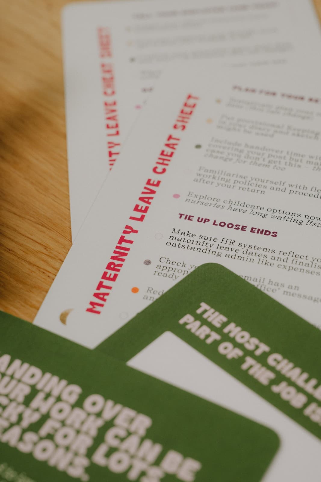 The Maternity Leave Cheat Sheet cards laid out on a desk